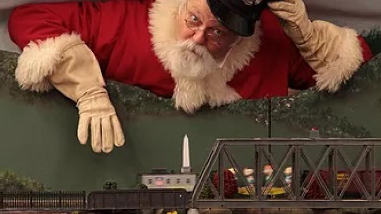 Santa overlooking the Holiday Train Garden at the Fire Museum of Maryland